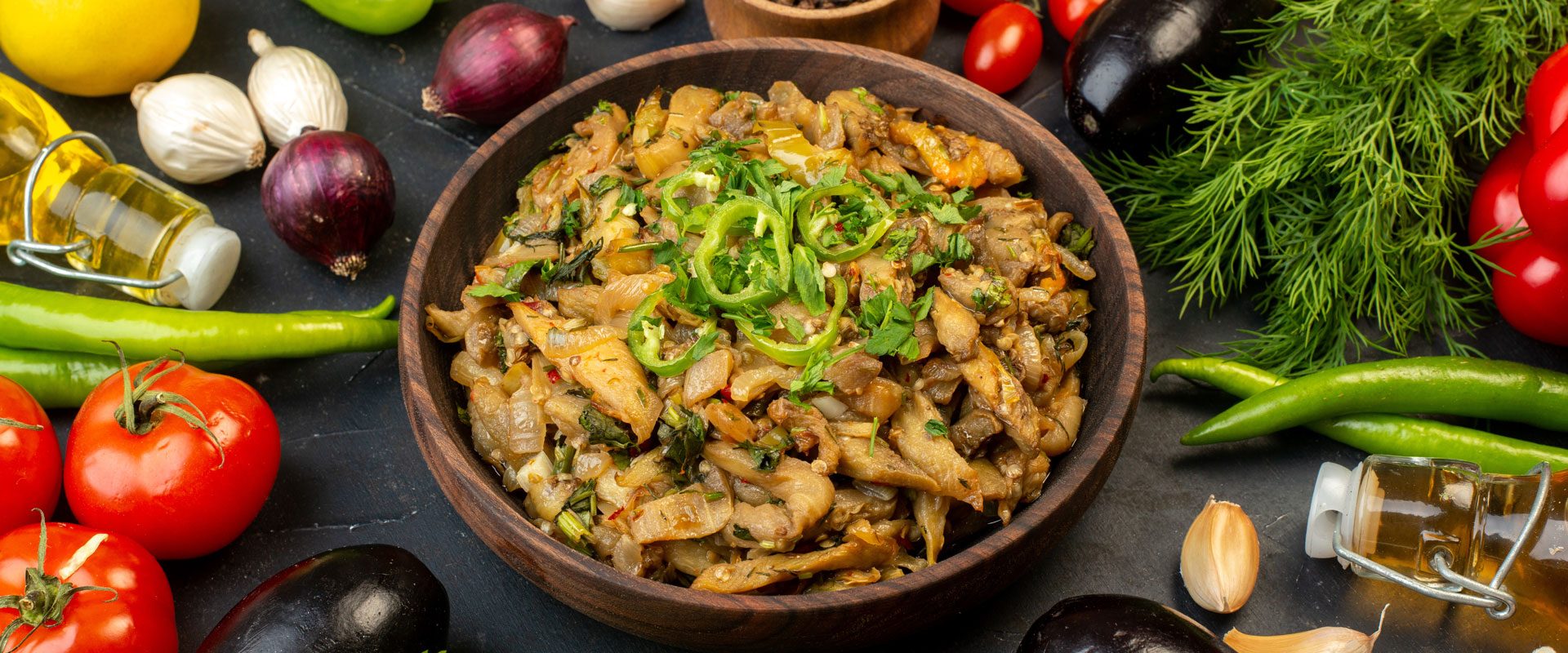 close-up-view-delicious-eggplant-meal-fresh-vegetables-spices-fallen-oil-bottle-green-bundle-dark-color-background