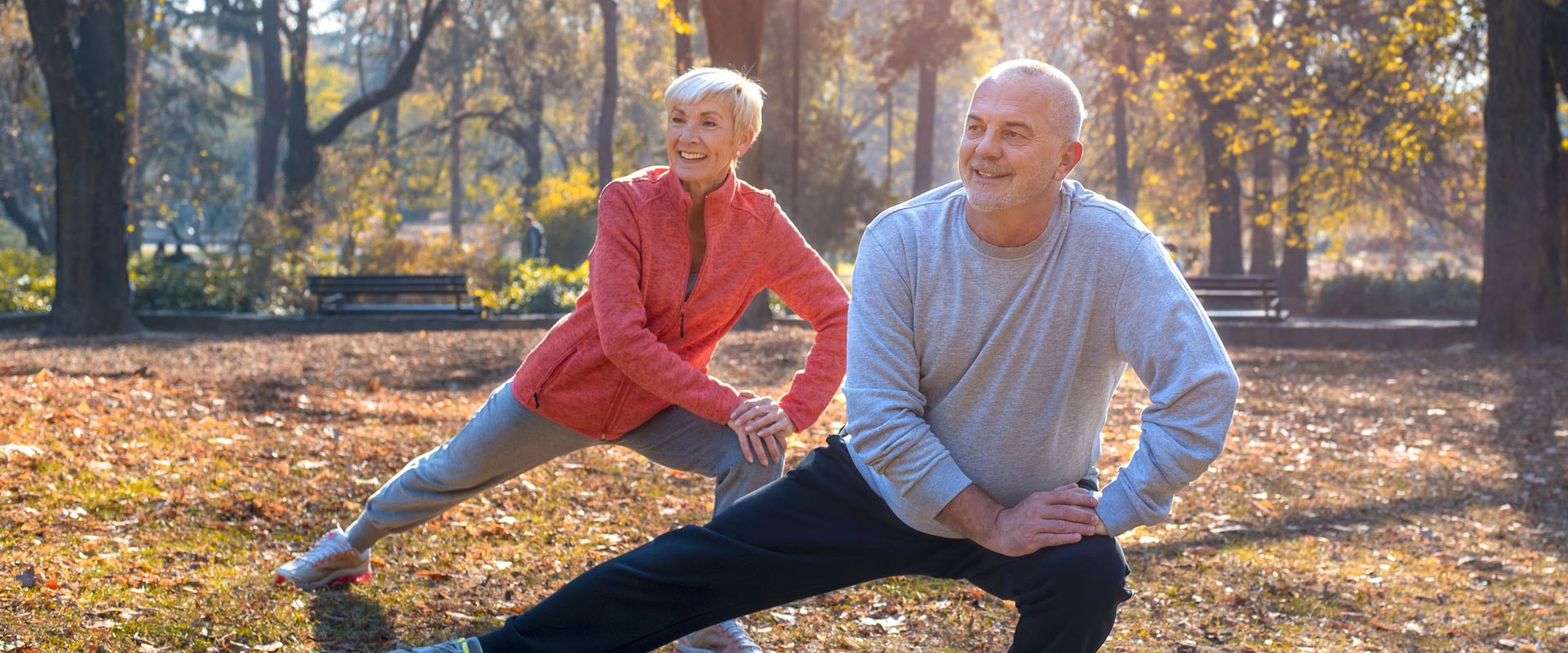 closeup-smiling-caucasian-senior-couple-exercising-park-sunny-autumn-day
