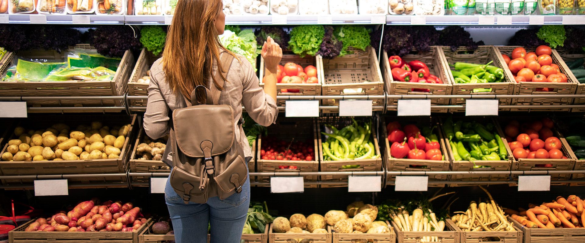 good-looking-woman-standing-front-vegetable-shelves-choosing-what-buy