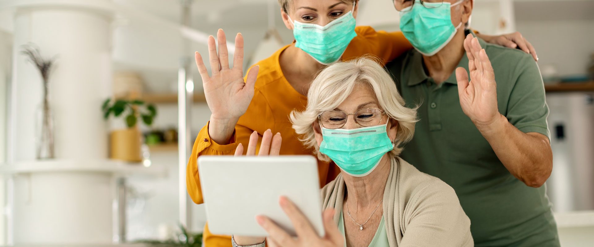happy-family-waving-while-having-video-call-touchpad-home-during-covid19-pandemic