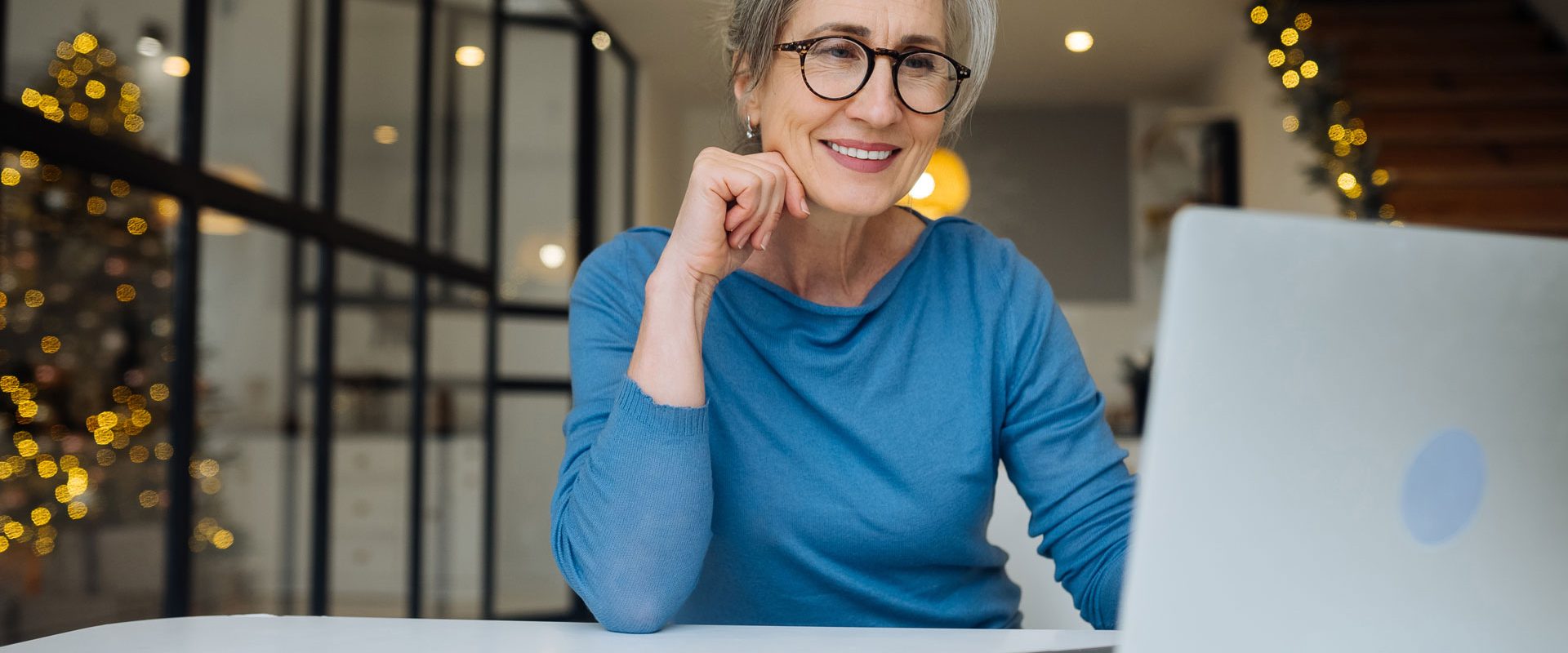 happy-mature-middle-aged-elderly-woman-reading-good-news-looking-laptop