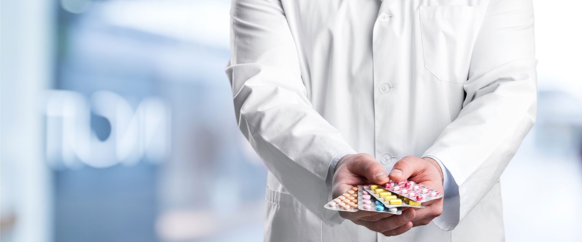male-doctor-holding-pack-different-tablet-blisters