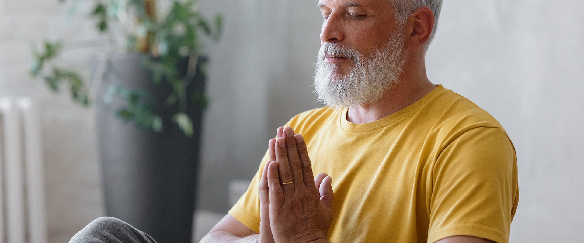 man-with-gray-hair-meditates-does-breathing-exercises-sports-fitness-physical-exercises