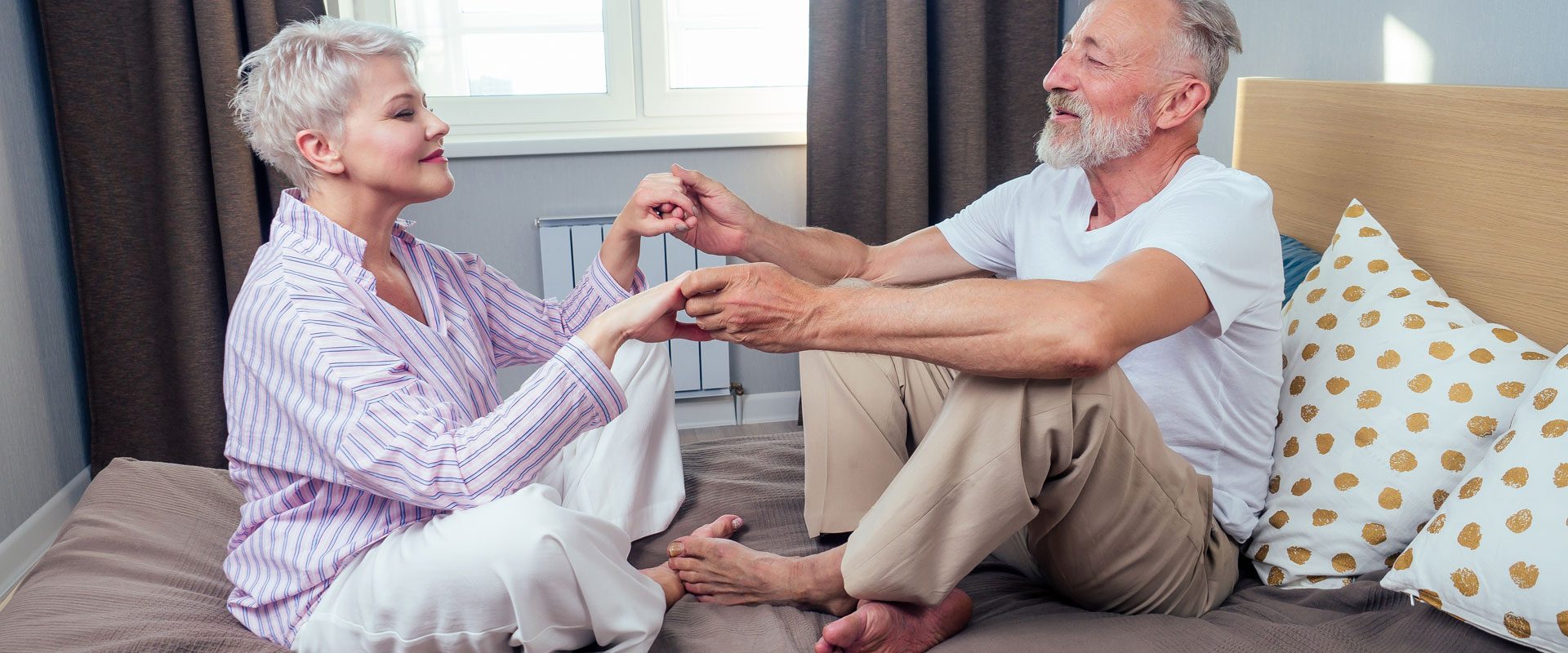old-couple-love-pajamas-touching-each-other-bedroommornind-day-light-from-big-window