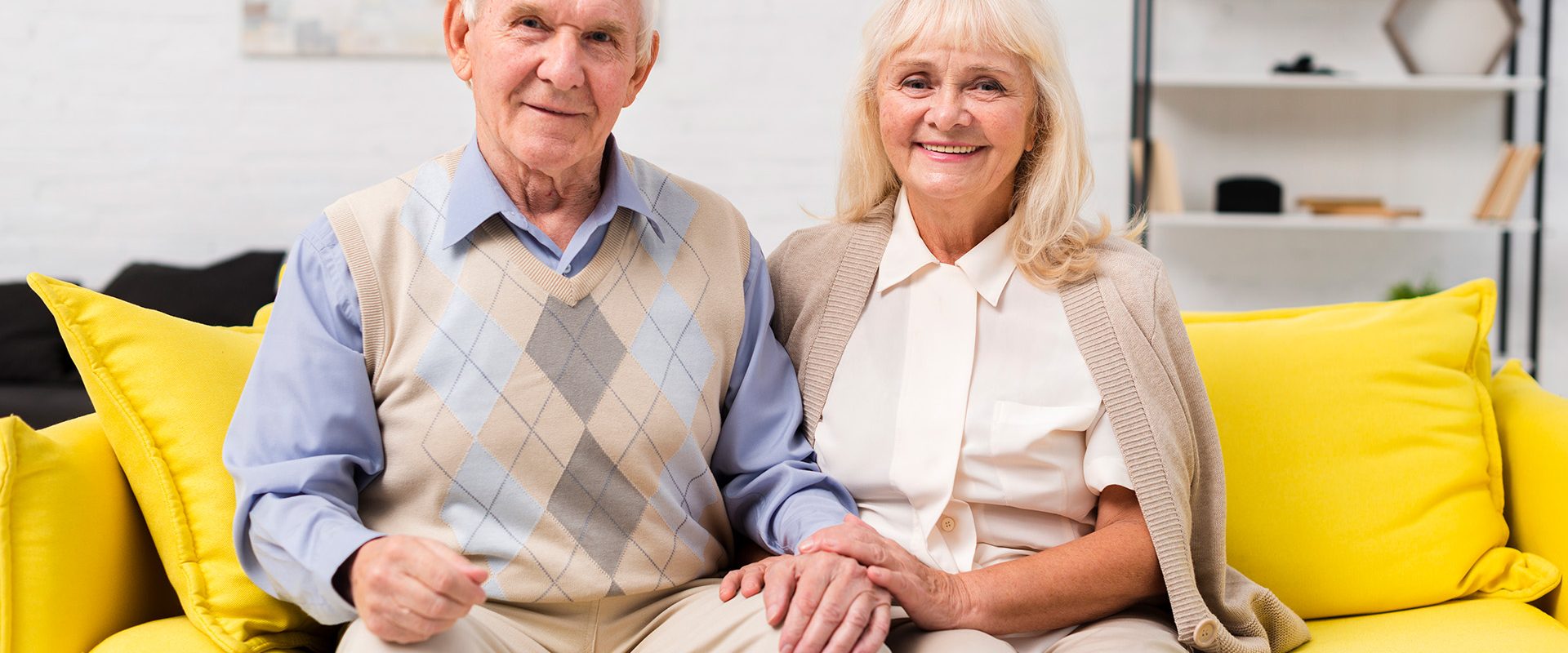 old-man-woman-sitting-yellow-sofa
