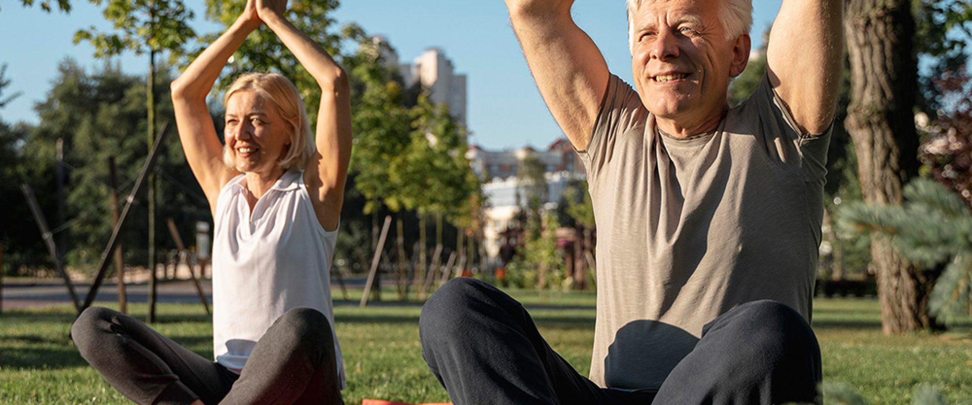 older-couple-practicing-yoga-outdoors
