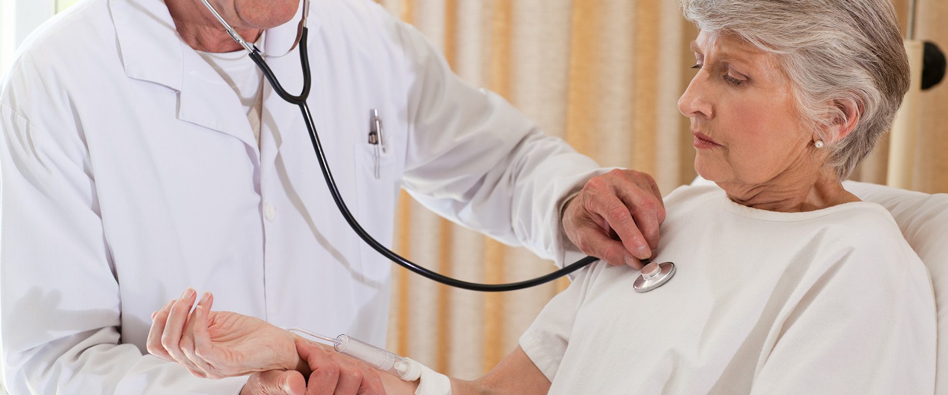 senior-doctor-taking-heartbeat-his-patient