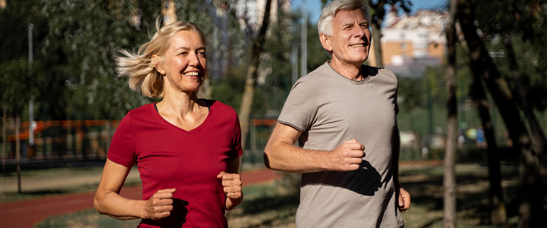 smiley-older-couple-jogging-outdoors